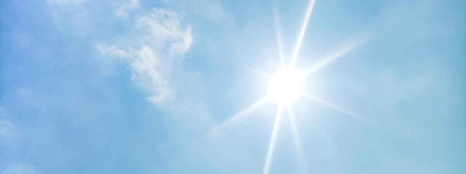 blue sky background and shining sun. Heat wave concept. Extreme weather. Global warming effects